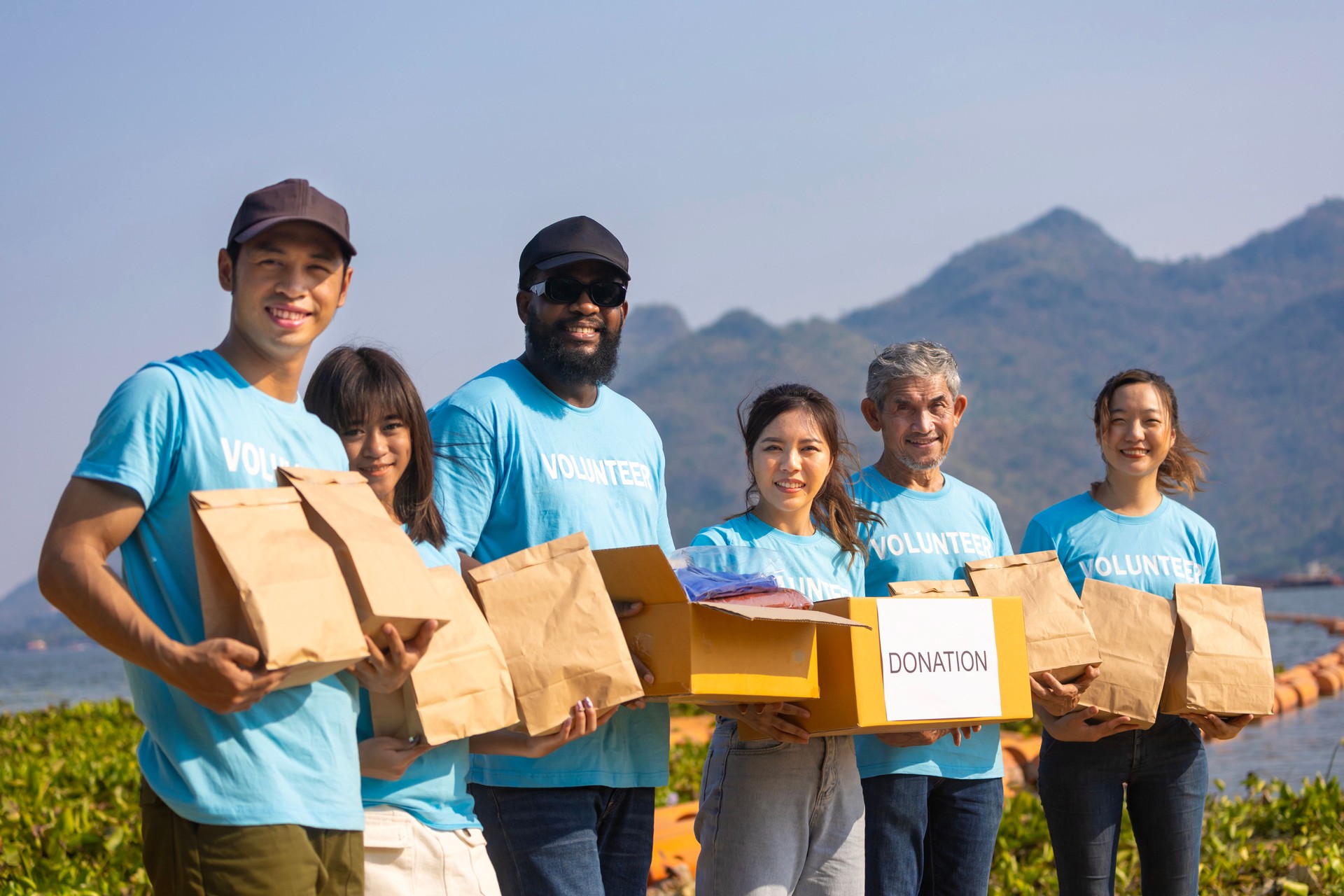 Diversity group of volunteer people joining together in money raising event for charity donation work and ngo related activity such as global warming, environmental issues, pollution and eco-friendly project